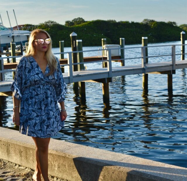 Woman walking by a waterfront dock.