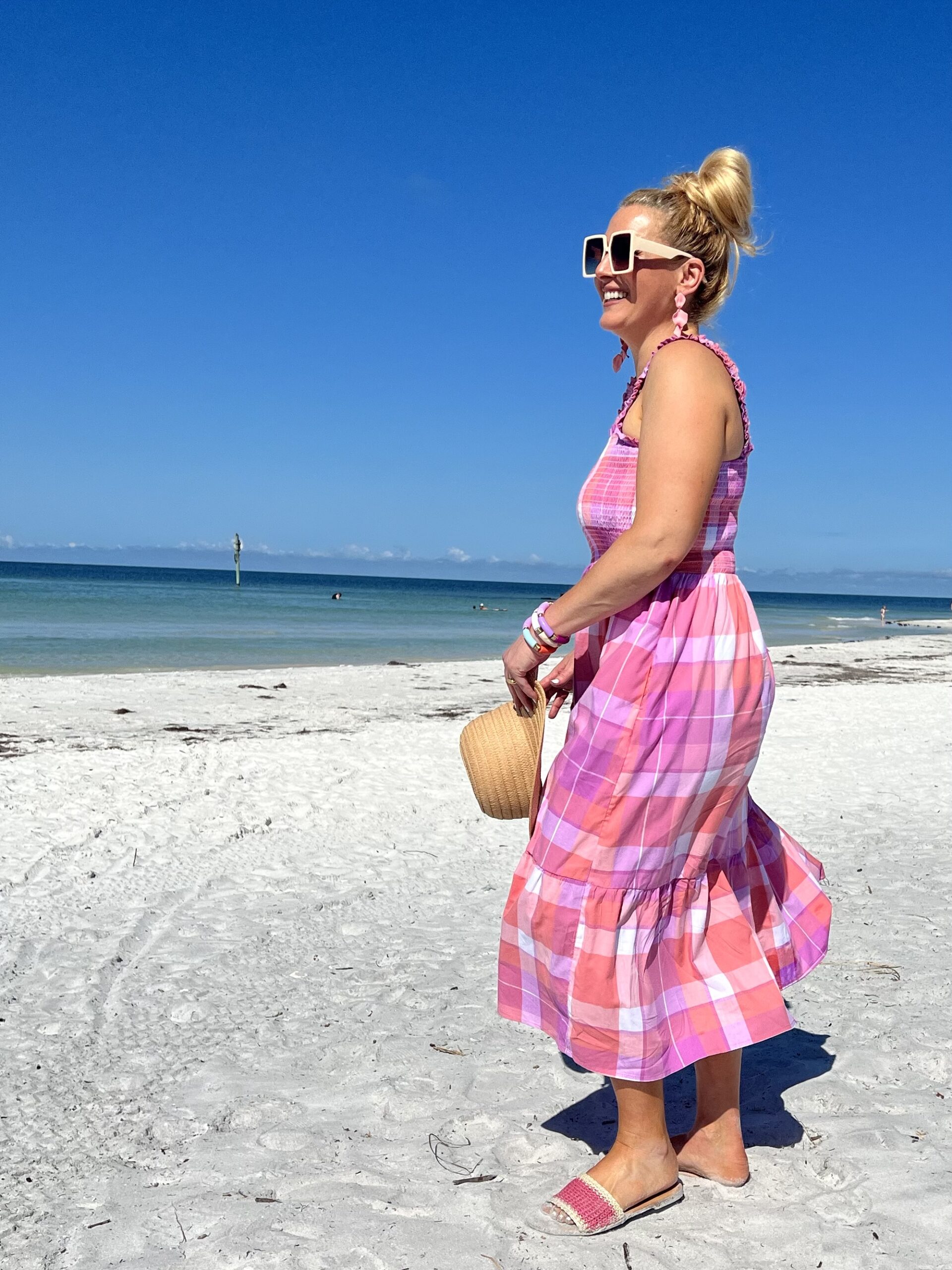 Jenn Truman Fashion Blogger @JTSTJTST11 is walking on the beach in Dunedin Florida while wearing an pink and purple Time and Tru midi dress from Walmart.